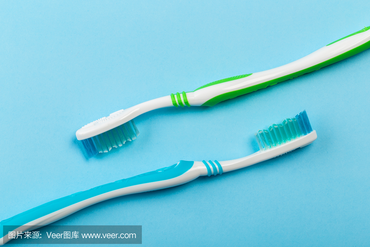 两把蓝色背景的新牙刷。牙科的概念